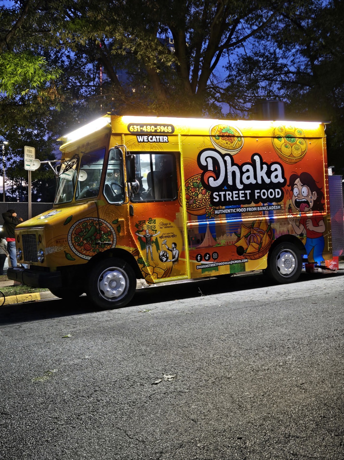 The Dhaka Street Food truck at dusk, lights on