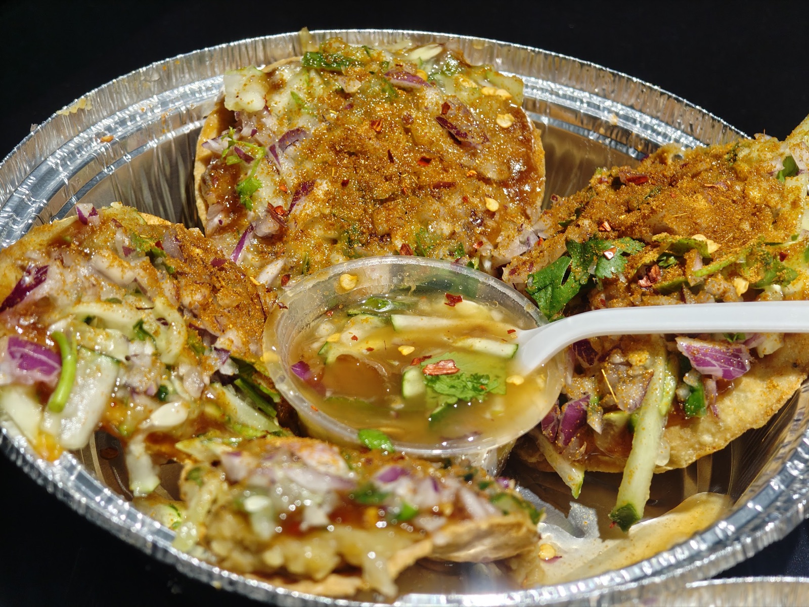 Fuchka with tamarind water and fresh herbs